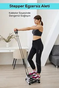 Woman using a stepper in a home setting with a desk and chair in the background.